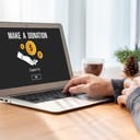 A person making a donation online using their laptop