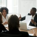 businessman disputing contract terms while pointing at a document during a meeting in the office