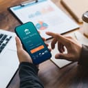 Male executive using smartphone to conduct online mobile banking, investing in stocks and mutual funds, retirement investment ideas.