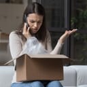 Dissatisfied angry woman, cheated client sit on sofa check received box