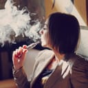 Woman vaping indoors