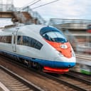 The electric train drives at high speed at the station