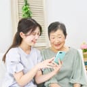 Older and younger woman looking at a phone