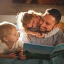 A father reading a book for his two children