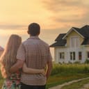 Couple hugging and looking at a village house