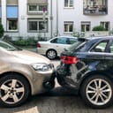 Two cars tightly parked