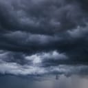 The dark sky with heavy clouds converging and a violent storm before the rain.Bad or moody weather sky and environment. carbon dioxide emissions, greenhouse effect, global warming, climate change