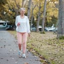 Middle-aged woman walks through park