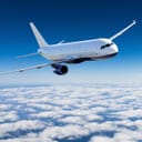 Passenger airplane flying in the sky above clouds