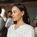 A woman sitting in the audience looking forward