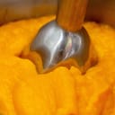 Close-up of a blender creating smooth pumpkin puree.