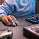 A boy using a gaming mouse and a mechanical gaming keyboard
