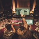 two men working together on a song in a recording studio