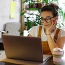 Young woman working on her laptop indoors