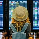 Woman looking at information boards at an airport