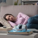 young woman taking a nap on a living room couch