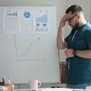 Man pressing his hand against the forehead as he is about to give a presentation