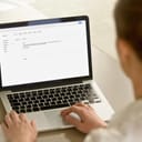 a woman writing an email on a laptop