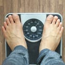 Man checking his weight on a scale