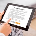 a person reading terms and conditions on a tablet