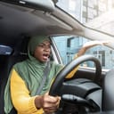 A woman in a car annoyed at the traffic.