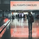 a girl exiting an airport terminal as all flights are canceled