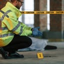 A police officer kneeling next to an evidence at the crime scene