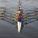 Rowers paddling on a picturesque Italian lake