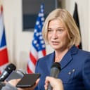 Senior government representative speaking to press