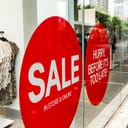 A large SALE sign on a shop window