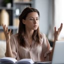 A woman frustrated while using her laptop