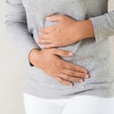 Woman holding her stomach in pain