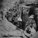 Black and white photo of WW1 trench with soldiers in it