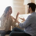 young couple arguing in their living room