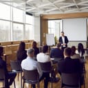 young man delivering a presentation or report to colleagues in a business room
