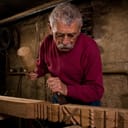 Elderly woodcarver at work in the workshop