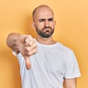 a pessimistic young man showing a thumbs-down gesture