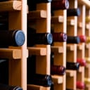 A wooden wine rack full with bottles of wine