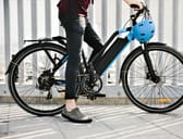 Person riding an e-bike in an urban setting