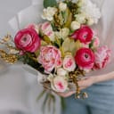 Bouquet for the bride in female hands. Flowers for the wedding. Leukadendron, ranunculus, genista. Tulips, roses, carnation shabot. Gift on the 8 march. Plans for valentines day.