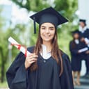 Girl wearing academic dress and holding her diploma