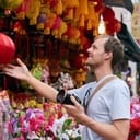 Tourist with a camera looking at oriental decorations