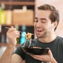 A man eating pasta