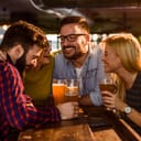 Friends in the Pub. Drinking beer, talking, having fun.