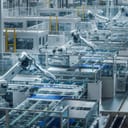 Large Production Line with White Industrial Robot Arms at Modern Bright Factory. Solar Panels are being Assembled on Conveyor. Automated Manufacturing Facility.