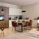 modern open-plan kitchen interior with a dining table and lamps