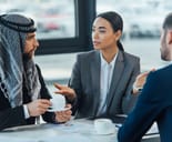 A woman interpreter translating to her client from Middle East