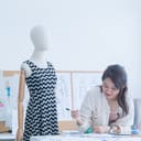female fashion designer creating designs in her studio workspace