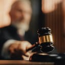 A judge silencing the court room with a gavel.