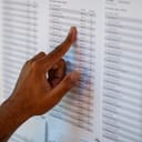 Man selecting a name from a long list